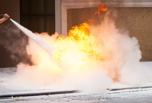 Fire-instructor showing how to use a fire extinguisher 