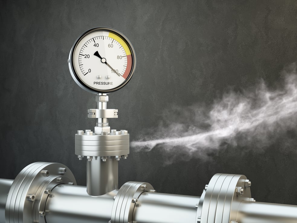 Gas or steam leaking from an industrial pressure gauge