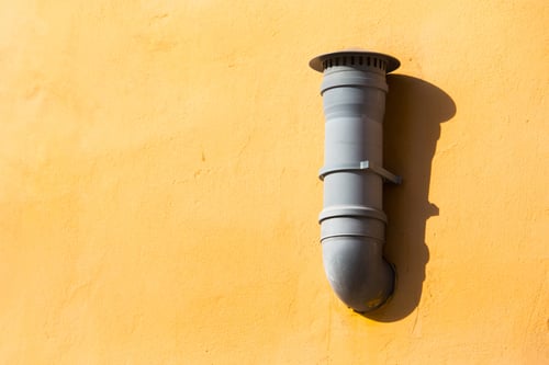 pipe mounted on exterior wall