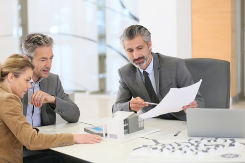 Mature couple meeting architect for construction project-2