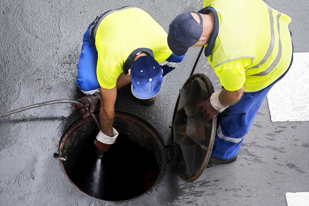 Sewerage workers working on the sewer line