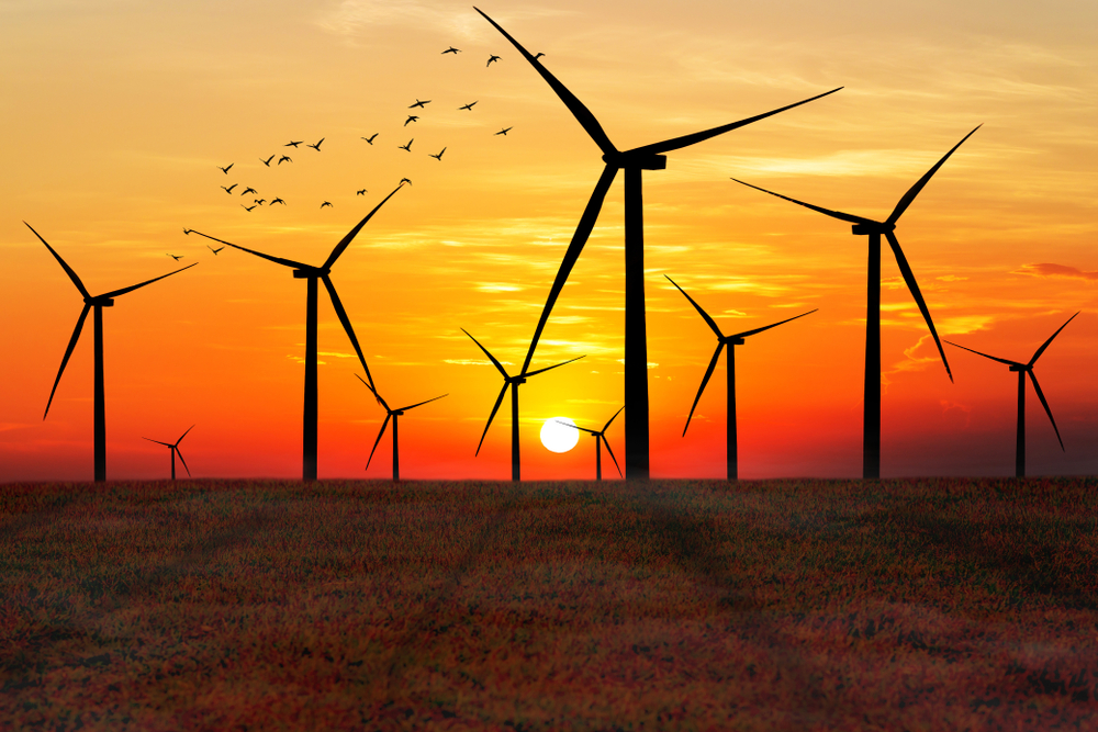 Silhouette of wind turbines at sunset